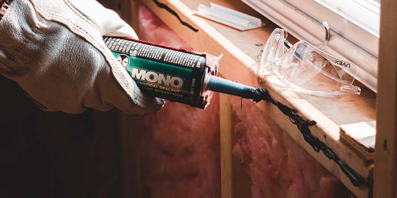 Preparing caulk for a window replacement.