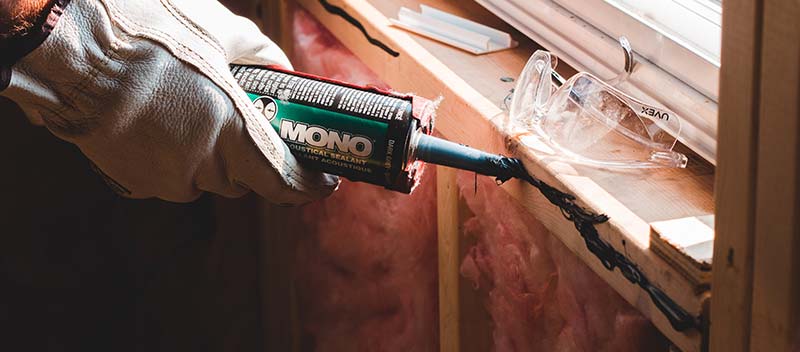 Preparing caulk for a window replacement.