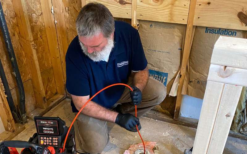 CrewPros employee performing a drain cam inspection.