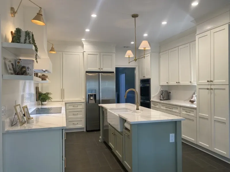 A modern kitchen with clean lines and soft color cabinets.