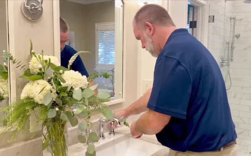 Checking the water pressure in bathroom sink.